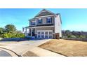 Two story house with gray siding, a three car garage and a manicured lawn at 201 Augusta Walk, Canton, GA 30114