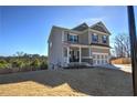 Two-story house with gray siding, a covered porch, and a large backyard at 201 Augusta Walk, Canton, GA 30114