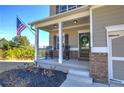 Charming front porch with rocking chairs and a wreath on the door at 201 Augusta Walk, Canton, GA 30114