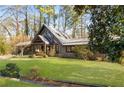 Unique home with modern architectural details, soaring windows, and a well-manicured front lawn at 3520 Still Rd, Cumming, GA 30041