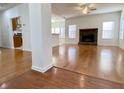 Hardwood floor living room, stone fireplace, and kitchen view at 4299 High Country Dr, Douglasville, GA 30135