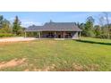 Gray house with covered porch and large yard at 701 Jones Mill Rd, Whitesburg, GA 30185