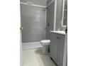 Modern bathroom featuring gray subway tile in the shower, hexagon tile floors, and gray vanity cabinet at 1971 Annette Ln, Austell, GA 30106