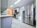 Modern kitchen with gray cabinets, stainless steel appliances, and light wood flooring at 284 Juliet Sw Ln, Marietta, GA 30008