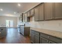 Gray cabinets, granite countertops, and kitchen island at 3732 Stonebranch Ln, Loganville, GA 30052