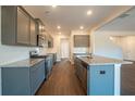 Modern kitchen featuring gray cabinets and granite countertops at 3732 Stonebranch Ln, Loganville, GA 30052