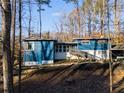 Ranch style home with blue siding, nestled in wooded setting at 1974 Ellwyn Dr, Brookhaven, GA 30341