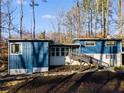 Mid-century modern home featuring a blue exterior and a spacious deck at 1974 Ellwyn Dr, Brookhaven, GA 30341