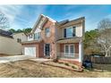 Two-story house with a brick facade, two-car garage, and a porch at 2013 Parador Bnd, Mcdonough, GA 30253