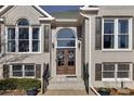 Elegant entryway with double doors and brick detailing at 409 E Point Dr, Canton, GA 30115