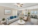 Open-concept living room with modern furnishings and a view into the kitchen and dining area at 7744 Fawn Cir, Covington, GA 30014