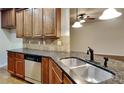 Kitchen with dark wood cabinets, granite countertops, and stainless steel appliances at 876 Nevis Way, Mcdonough, GA 30253