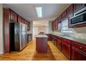 A kitchen with stainless steel appliances, wood cabinets, and hardwood floors at 2400 Stedman Sw Ln, Conyers, GA 30094