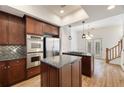 Modern kitchen with stainless steel appliances, granite countertops, and a gas cooktop island at 3245 Buckhead Forest Ne Mews, Atlanta, GA 30305