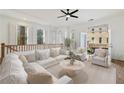 Bright living room features a white sectional sofa, area rug, and doors to an outdoor balcony at 3245 Buckhead Forest Ne Mews, Atlanta, GA 30305