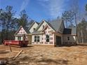 New home construction featuring gray shingles, light siding, and a spacious layout in a wooded lot at 6851 Phillips Mill Rd, Douglasville, GA 30135