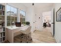 Bright home office featuring built-in bookshelves, a modern desk, and a pleasant outdoor view at 2736 Joyce Ave, Decatur, GA 30032