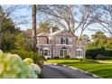 Lovely red brick home with manicured landscaping and mature trees surrounding the property at 3180 Arden Nw Rd, Atlanta, GA 30305