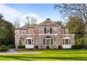 Beautiful brick home featuring arched windows and a well-maintained lawn for great curb appeal at 3180 Arden Nw Rd, Atlanta, GA 30305