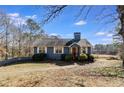 Blue Ranch style home with a yard and wooded lot at 446 Mcgukin Rd, Bremen, GA 30110