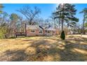 Brick ranch house with a large yard and mature trees at 12205 Highway 36, Covington, GA 30014
