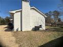 Side view of the house showing a new HVAC unit and a large backyard at 1902 E Piedmont Rd, Marietta, GA 30062