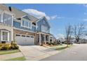 Beautiful two-story townhome featuring a brick front, an attached two-car garage, and manicured landscaping at 204 Dawson Dr, Woodstock, GA 30188