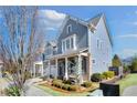 Attractive townhome with blue siding, brick accents, and professional landscaping, creating curb appeal at 204 Dawson Dr, Woodstock, GA 30188