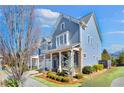 Attractive townhome with blue siding, brick accents, and professional landscaping, creating curb appeal at 204 Dawson Dr, Woodstock, GA 30188