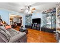 Living room with hardwood floors and large TV at 24 Planters Sw Dr, Lilburn, GA 30047