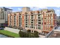 Multi-story condominium building with brick and stone accents, multiple balconies, and manicured green space at 250 Park W Ave # 701, Atlanta, GA 30313