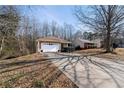 House with a driveway and large backyard at 4458 English Loop, Lithonia, GA 30038