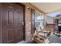 Front porch with stonework, two chairs, and a grill at 4458 English Loop, Lithonia, GA 30038