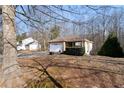 House with a large front yard and mature trees at 4458 English Loop, Lithonia, GA 30038