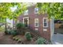 Brick two-story house with double doors, landscaping, and partial basement at 2339 Milstead Cir, Marietta, GA 30066