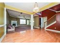 Bright dining room with hardwood floors and a view into the living room at 5399 Emily Cir, Ellenwood, GA 30294