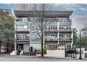 Modern building facade with multiple balconies and well-maintained landscaping at 33 Ponce De Leon Ne Ave # 203, Atlanta, GA 30308