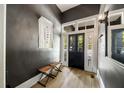 Welcoming entryway with modern lighting, hardwood floors, and dark gray accent walls, leading into the home at 66 Howell Ne St, Atlanta, GA 30312