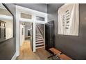 Open entryway with hardwood floors, a modern mirror, and a view of the staircase, creating a bright space at 66 Howell Ne St, Atlanta, GA 30312