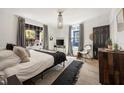 Serene main bedroom with large windows, stylish decor, and hardwood floors, offering a relaxing atmosphere at 66 Howell Ne St, Atlanta, GA 30312