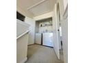 Upper-level laundry room with washer and dryer at 6921 Foxmoor Way, Douglasville, GA 30134