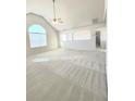 Light-filled living room featuring vaulted ceilings, neutral carpet, and large windows, offering great space at 6921 Foxmoor Way, Douglasville, GA 30134