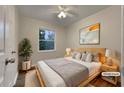 Virtually staged bedroom with a queen-size bed and wood floors at 170 Eldorado Dr, Carrollton, GA 30116