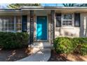 Close-up of home entrance showing a turquoise front door, framed by black decorative ironwork at 3448 Montreal Way, Tucker, GA 30084