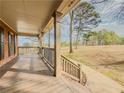 Spacious front porch with wooden floors and railing, overlooking yard at 3657 Linda Dr, Loganville, GA 30052