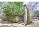 View of a home's side entrance featuring a lovely landscaped yard with mature trees and bushes at 3103 Colonial Way # A, Chamblee, GA 30341