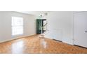 Bright living room featuring hardwood floors, a green front door, and a staircase at 3103 Colonial Way # A, Chamblee, GA 30341