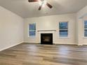 Living room featuring hardwood floors and a fireplace at 4444 Spring Mtn Ln, Powder Springs, GA 30127