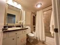 Cozy bathroom with shower-tub combo, white cabinets, granite sink, and decorative mirror at 2249 Runnymead Se Rdg, Marietta, GA 30067