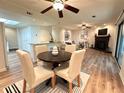 Open-concept dining area with wood floors, stylish chairs, and seamlessly connected living spaces at 2249 Runnymead Se Rdg, Marietta, GA 30067